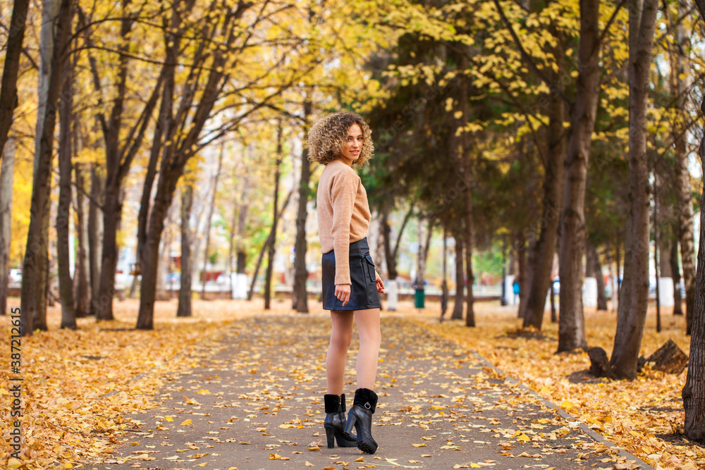 Portrait of a young beautiful girl in beige sweater and black skirt Portrait of a young beautiful girl in beige sweater and black skirt
