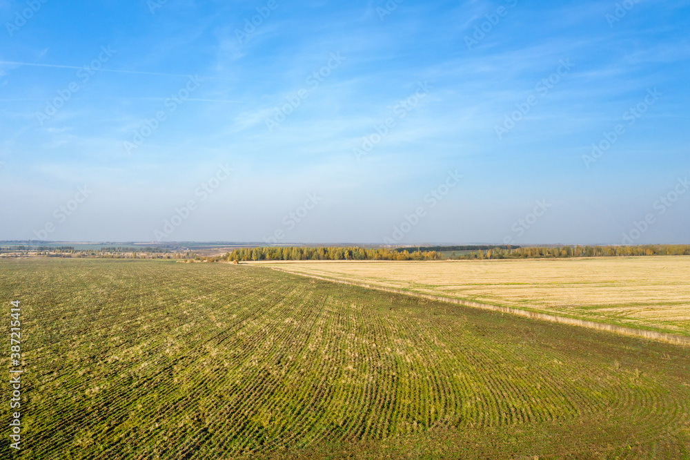 Aerial view of harvested agricultural fields on autumn day