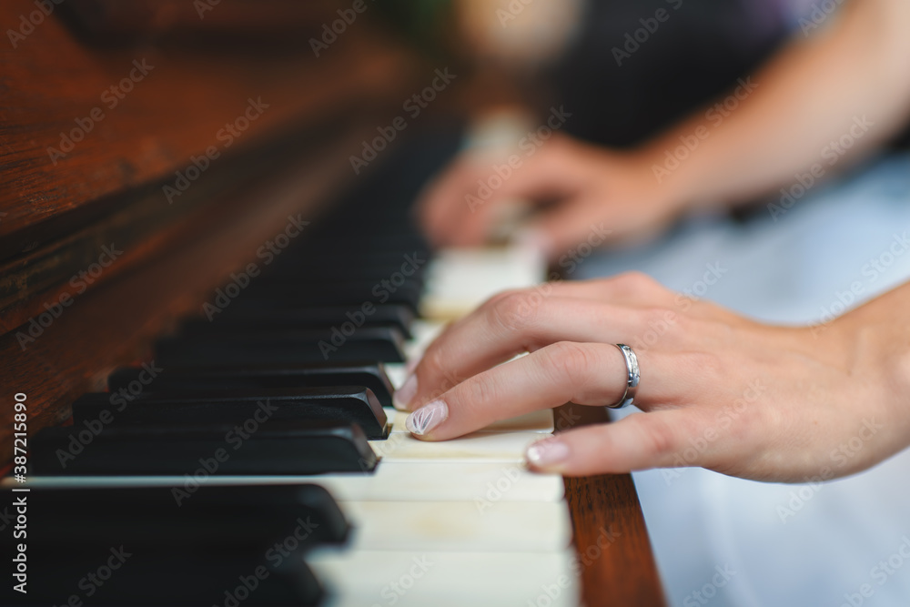 The woman's hands playing the piano.