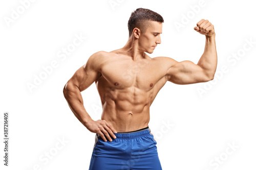 Strong muscular guy flexing one bicep muscle