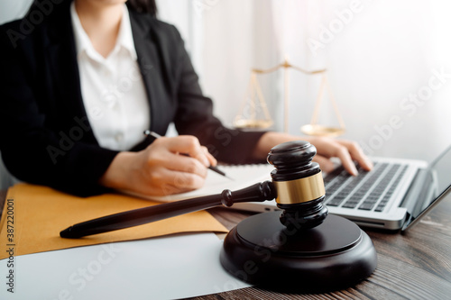 justice and law concept.Male judge in a courtroom on wooden table and Counselor or Male lawyer working in office. Legal law, advice and justice concept.