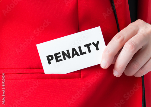 girl holds a business card with the written word penalty, close-up card in korman
