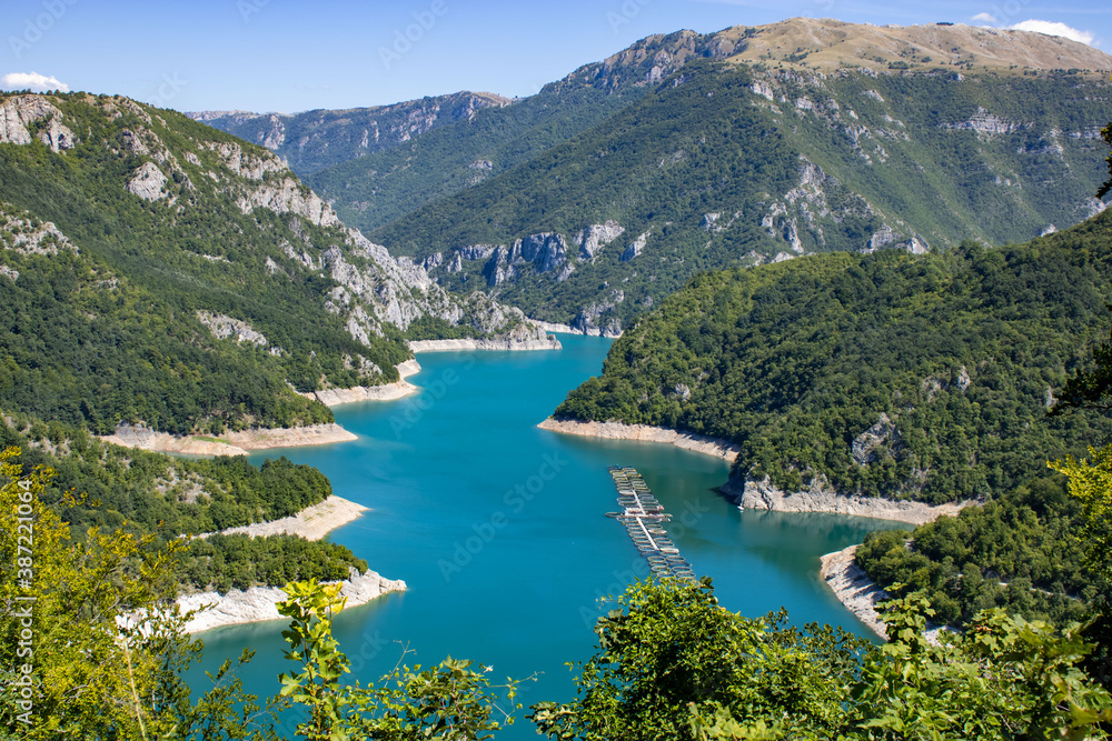 
Beautiful landscape Mountain lake of azure color. Oyster farm. View from above. Sunny day, clouds. Montenegro.