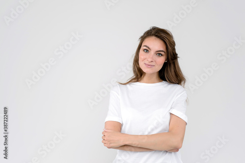 Portrait of smiling woman, isolated on white background, with folded arms