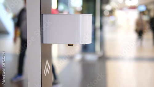 Close up of hand sprayed by contactless auto sanitizer dispenser device. Personal protection during coronavirus pandemic photo