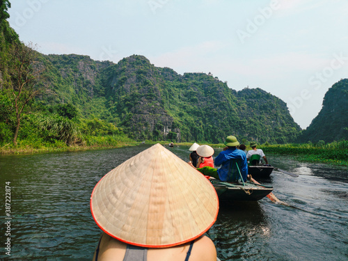 Tourist on a boat tour in Tam Coc, Ninh Binh, Vietnam