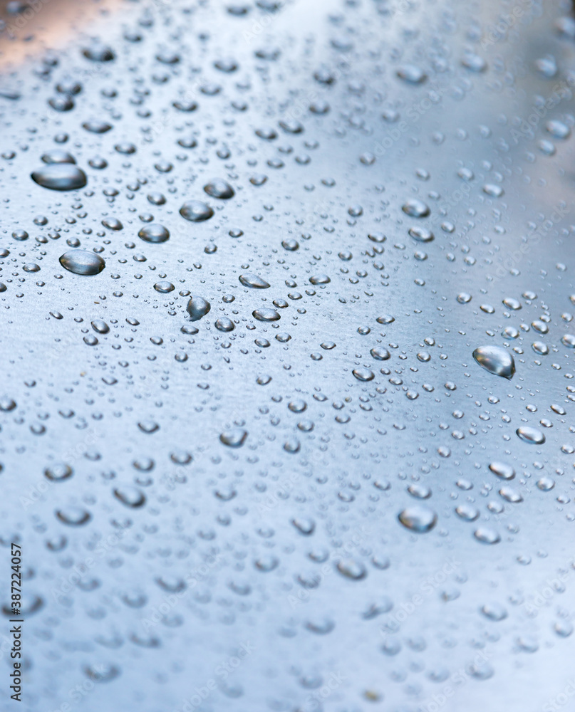 Water drops on a metal surface, background, shallow depth of field. Water drops on a metal surface, background, shallow depth of field.