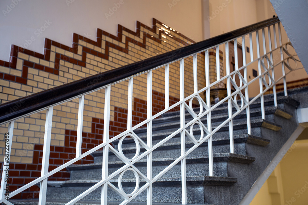 Obraz premium Old historic building with luxury stairs and tiled wall, beautiful marble design of old building and white handrail