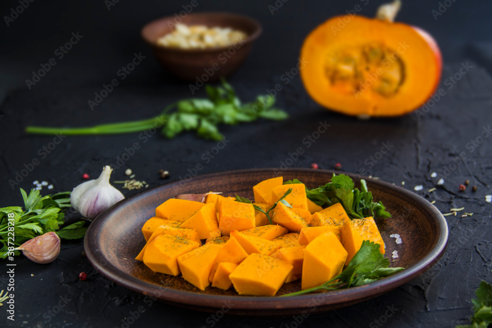 Beautifully chopped pumpkin salad, herbs, and ingredients for the dish. Creative atmospheric decoration Beautifully chopped pumpkin salad, herbs, and ingredients for the dish. Creative atmospheric decoration