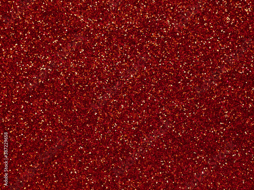 A glittery red paper. Golden glitter light bokeh abstract texture. Pattern designs. Sparkle wallpaper for Christmas. Brilliance shimmering sequin background. Party time.