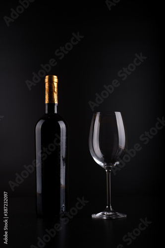 wine bottle and glass with black background