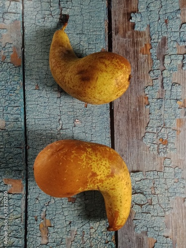 Two curved pears on wooden background