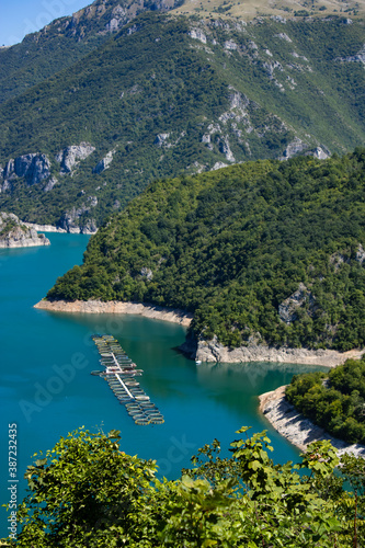 Beautiful landscape Mountain lake of azure color. Oyster farm. View from above. Sunny day, clouds. Montenegro.