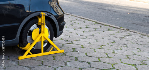 a blockade on the wheel of a car parked forbidden