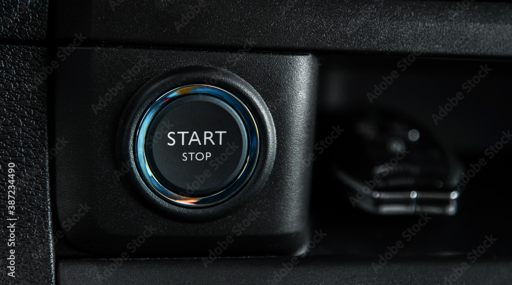 close up round button start car engine with backlight