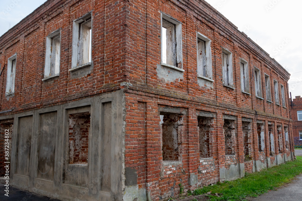 abandoner old red brick building without roof in town