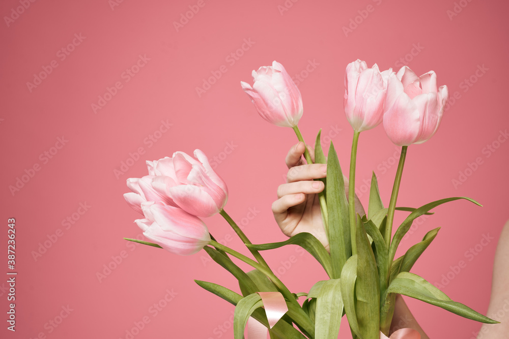 Fototapeta premium Bouquet of flowers as a gift holiday on March 8 pink background