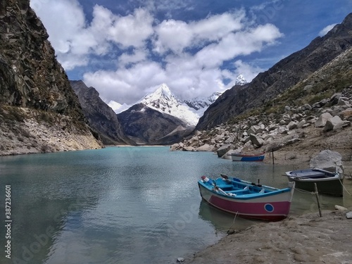 Boats at Laguna Paron, Huaraz, Peru. A blue-green lake in the Cordillera Blanca on the Peruvian Andes. At 4185 meters above sea level, it's surrounded by snowy peaks and a pyramid mountain. 