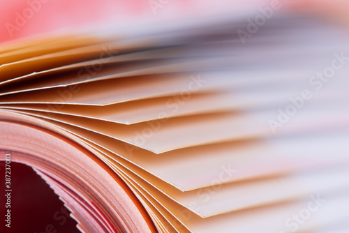 Macro edge of colorful magazine paper with blurred background