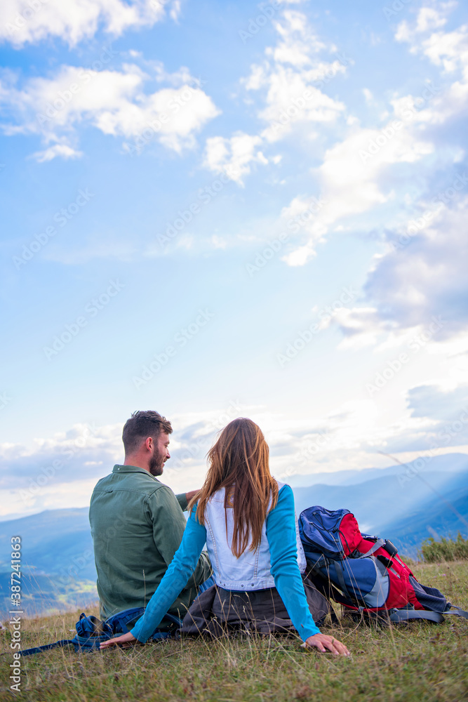 Couple Sitting On A Rock Resting During Hike