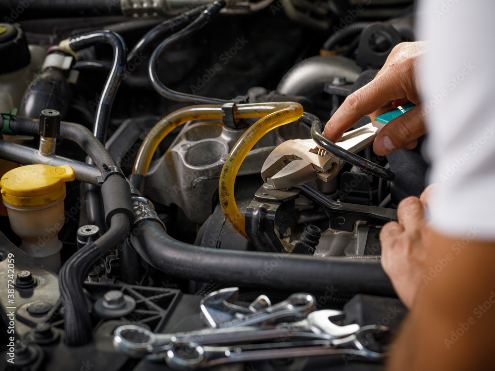 Auto mechanic working in garage. Repair service. Auto mechanic working in garage. Repair service.