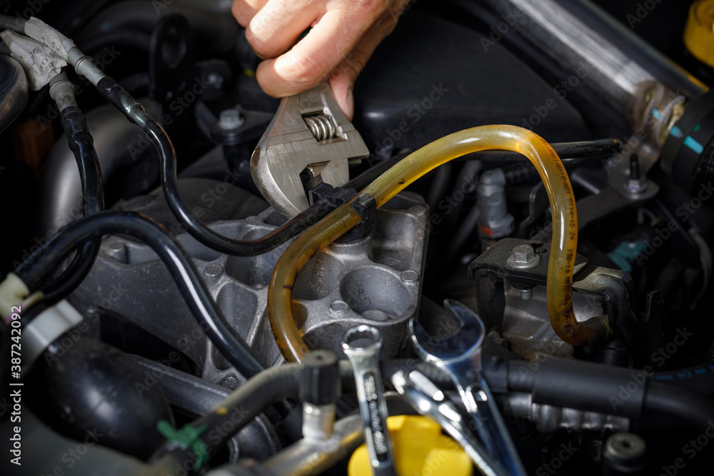 Auto mechanic working in garage. Repair service. Auto mechanic working in garage. Repair service.