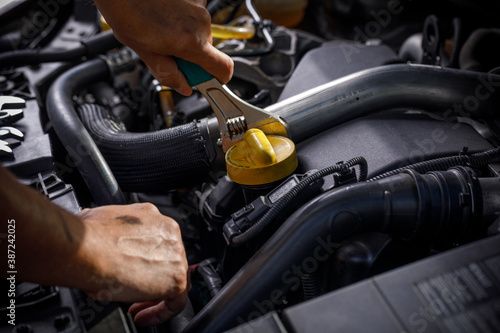 Auto mechanic working in garage. Repair service.