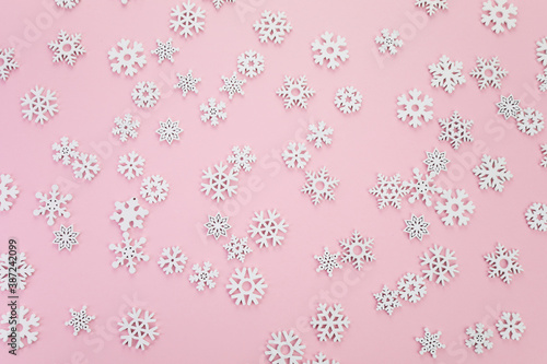 Snow flakes pattern on pink background. Top view