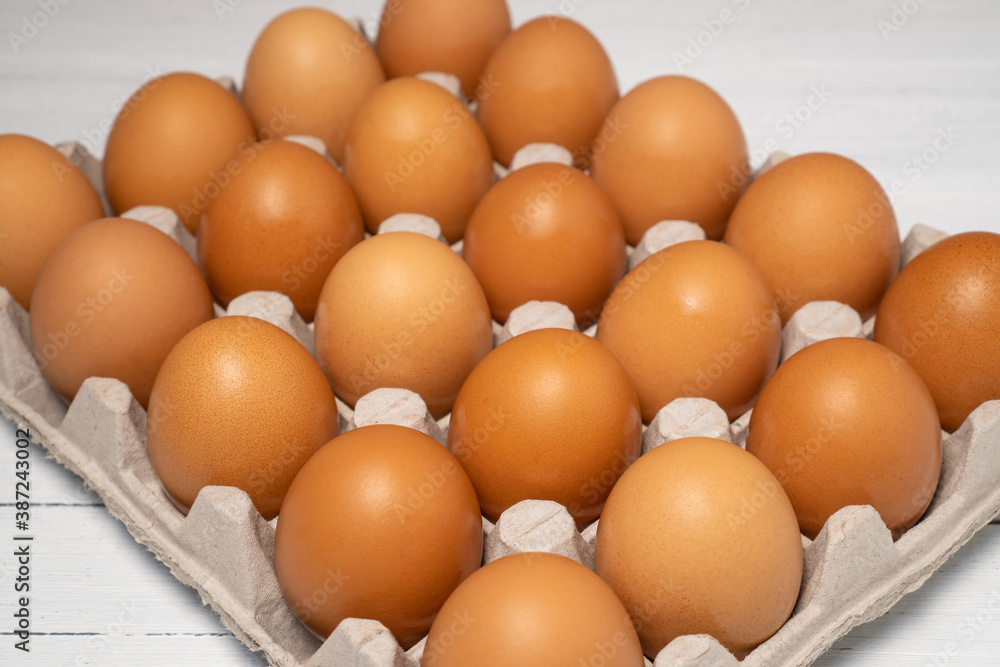 Brown raw chicken eggs in large cardboard package. Brown raw chicken eggs in large cardboard package.