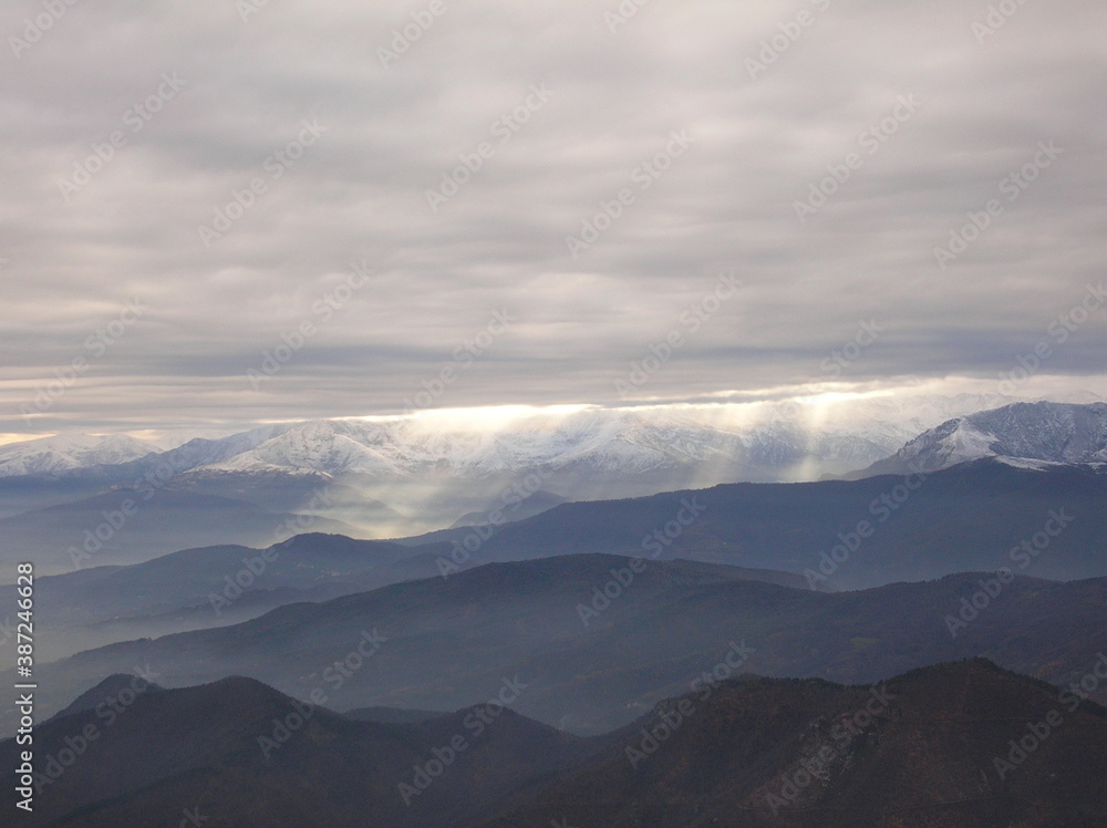 clouds over the mountain with beams of sunlight