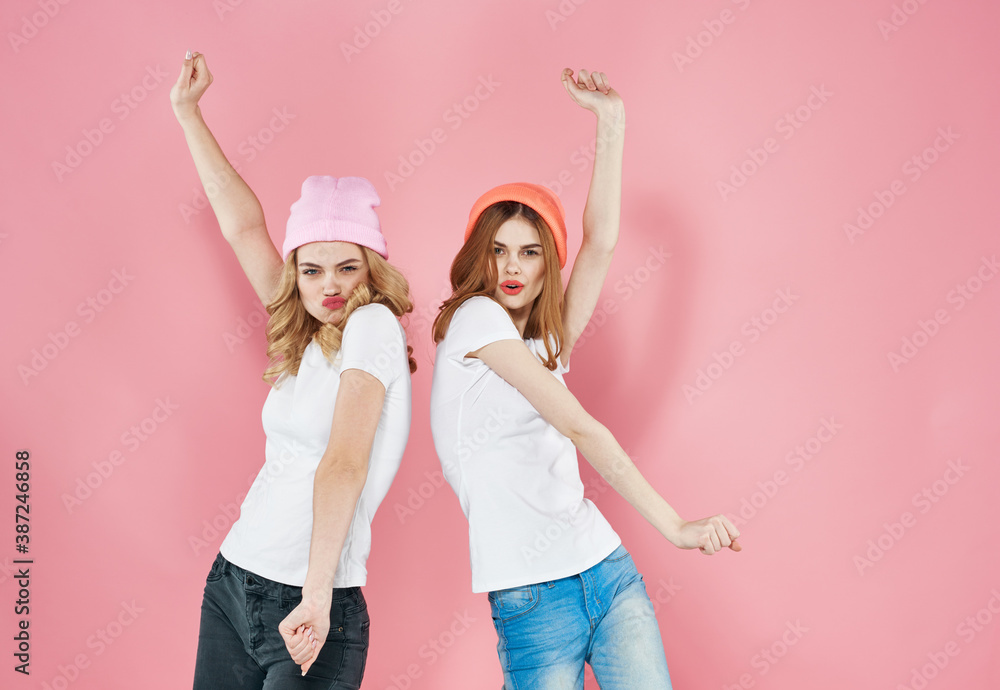 Two girlfriends fashionable clothes fun and joy lifestyle pink background Two girlfriends fashionable clothes fun and joy lifestyle pink background