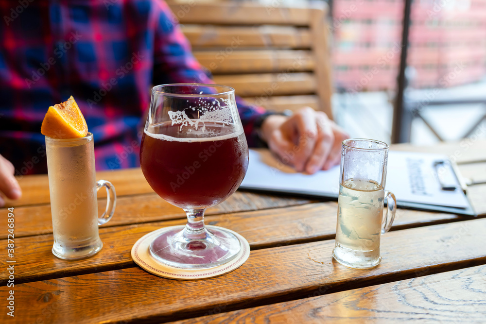The concept of alcoholism, the fight against alcohol addiction, depression. A man drinking alcohol alone in a bar. The concept of alcoholism, the fight against alcohol addiction, depression. A man drinking alcohol alone in a bar.