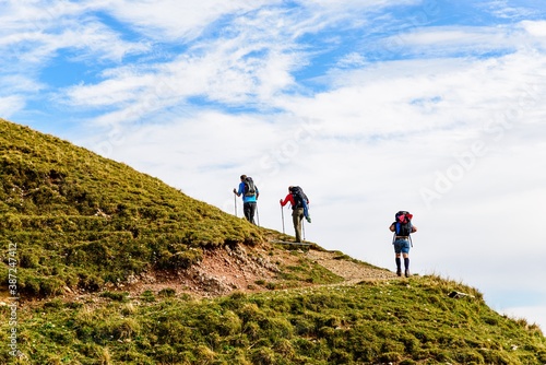 Peaple walking in mountains. Good hiking way. View from Hochgrat mountain nearby Oberstaufen (Bavaria, Bayern, Germany)
