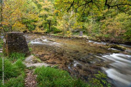 Long exposure of the river Barle flowing through the Barle Valley at Tarr Steps in Exmoor National Park photo