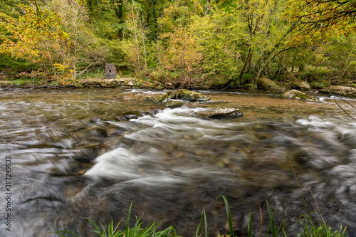 Long exposure of the river Barle flowing through the Barle Valley at Tarr Steps in Exmoor National Park photo