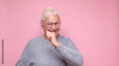 Happy senior woman in glasses having fun dancing