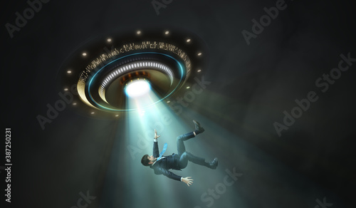 Photo Alien abduction concept. Young man is abducted by UFO.
