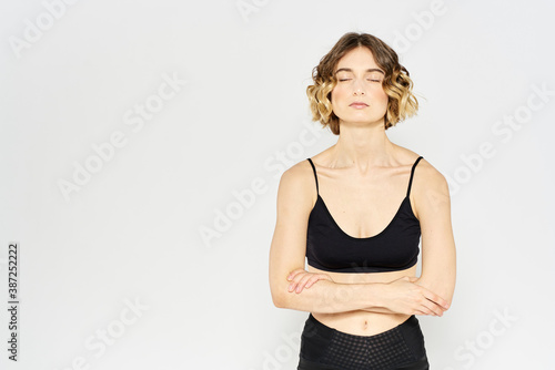 Slender woman in leggings on a light background doing fitness gymnastics exercises © SHOTPRIME STUDIO
