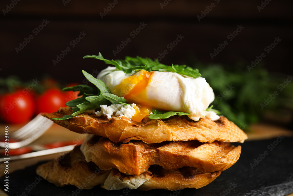 Delicious sandwich with arugula and egg on slate board, closeup