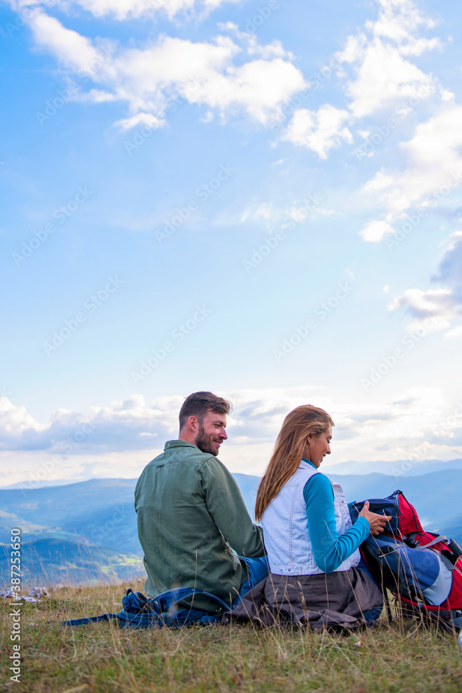 Couple Sitting On A Rock Resting During Hike