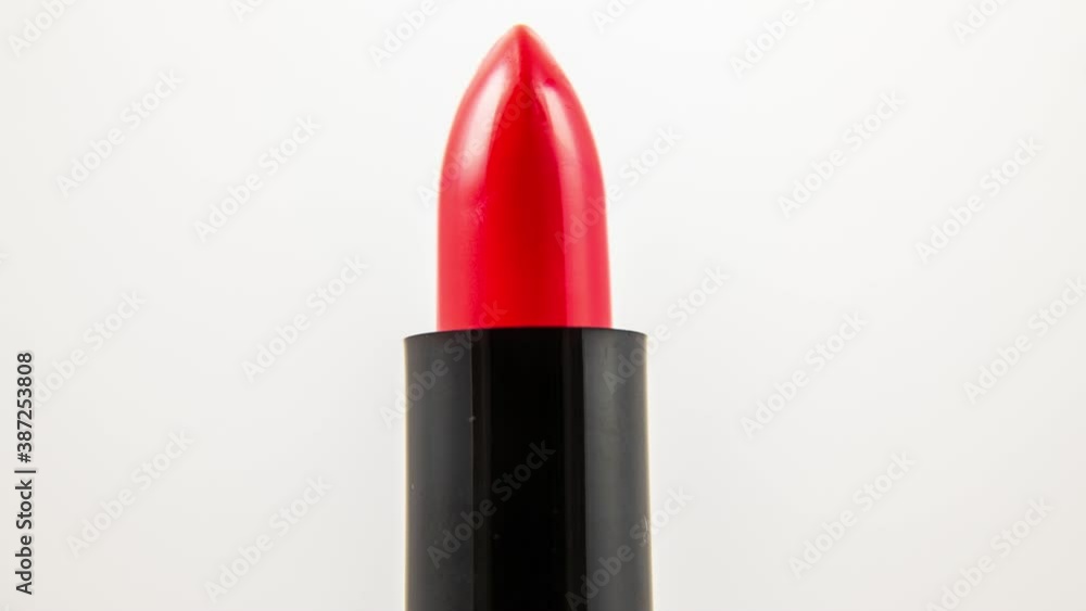 Close up video of red lipstick rotating in studio Close up video of red lipstick rotating in studio
