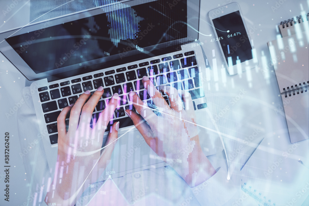 Double exposure of woman hands working on computer and forex chart hologram drawing. Top View. Financial analysis concept. Double exposure of woman hands working on computer and forex chart hologram drawing. Top View. Financial analysis concept.