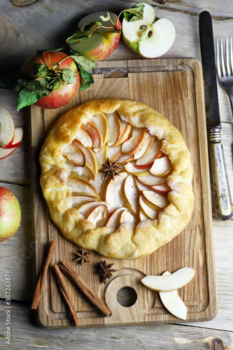 Apple biscuit on a wooden board. Galette. Homemade baking. Desserts with apples.
