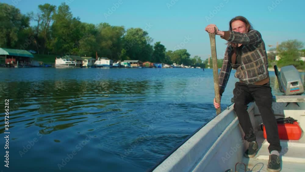 Joyful man is rowing over river marina in sunset Joyful man is rowing over river marina in sunset