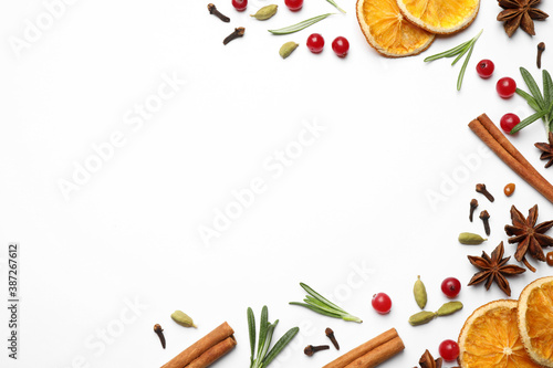 Different mulled wine ingredients on white background, flat lay. Space for text