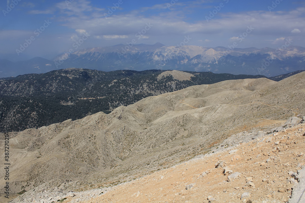 Summit of Tahtali Dag (Olympos Mountain), 2365 m MSL with steep slope visible on foreground and turkish Taurus Mountains range in the background, Kemer, Antalya Region