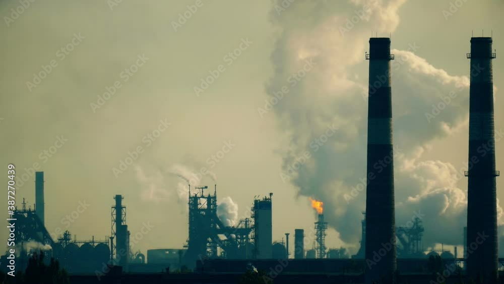 Industrial factory close up. Gas, steam and smoke background. Metallurgical industrial factory. Poisoned air. Epic pollution of nature. Toxic substances. Industrial factory close up. Gas, steam and smoke background. Metallurgical industrial factory. Poisoned air. Epic pollution of nature. Toxic substances.