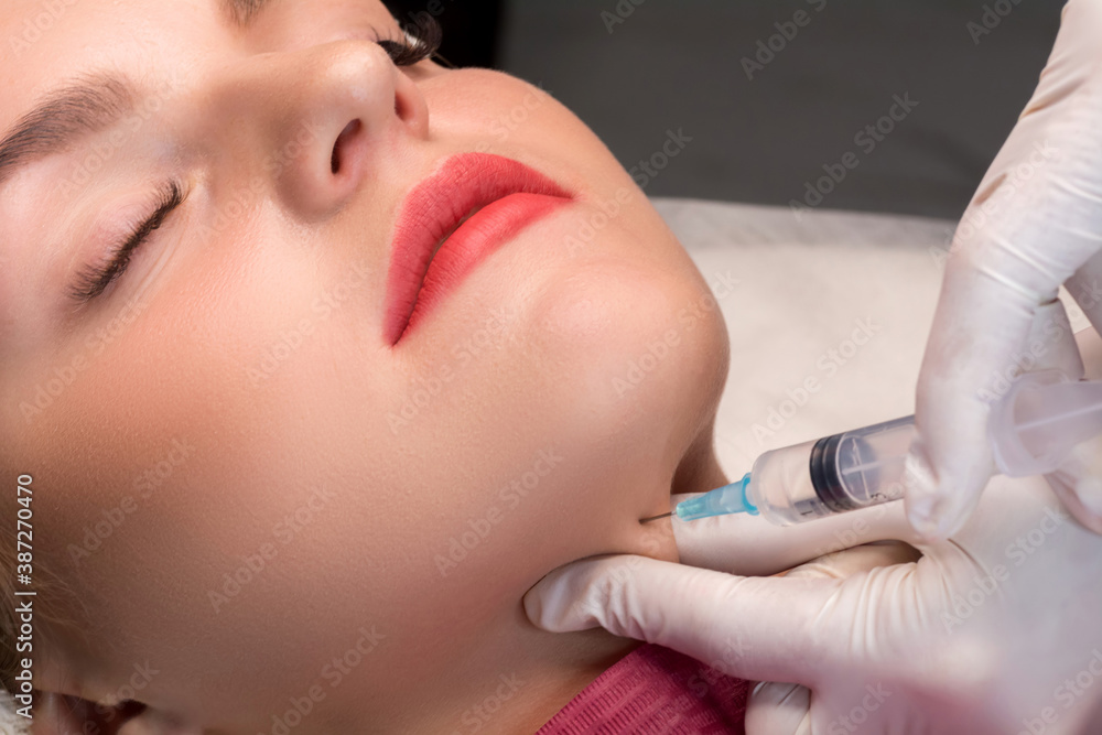 Chin lipofilling. Woman getting cosmetic injection of botulinum