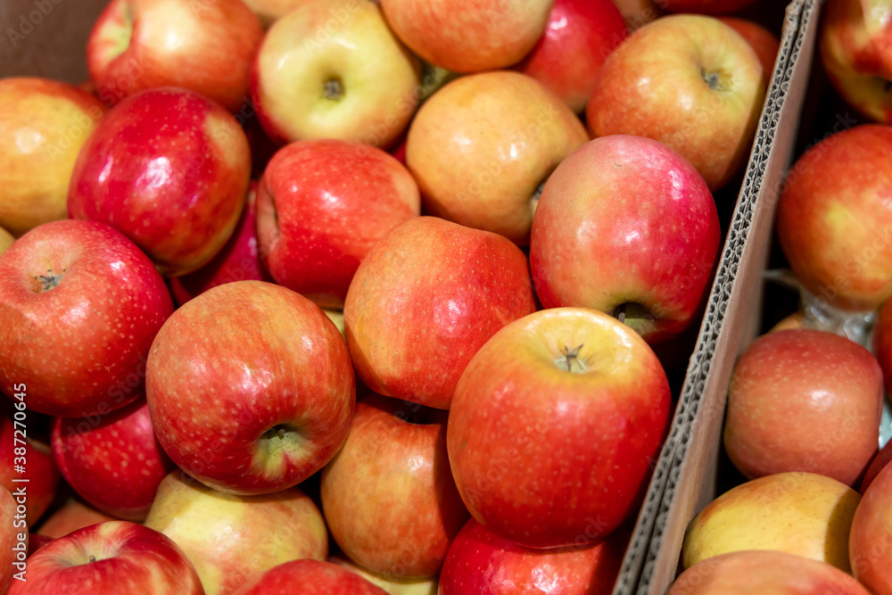 Ripe red apples in a cardboard box at a grocery store Ripe red apples in a cardboard box at a grocery store