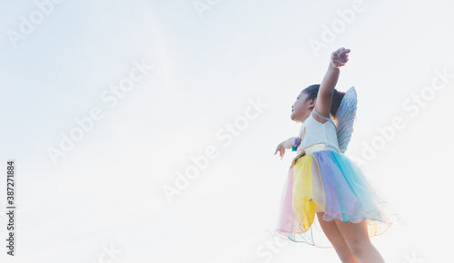 little girl flying, little girl in fairy costume, sky background
